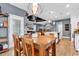 Dining area adjacent to the kitchen and living room, with wood floors and contemporary lighting at 28 Pinnacle Dr., Murrells Inlet, SC 29576