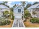 Exterior view of a blue two-story home with a white garage door and driveway at 28 Pinnacle Dr., Murrells Inlet, SC 29576