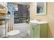 Bathroom with a teal vanity, shower/tub combo, and shelving at 3055 Chestnut St., Loris, SC 29569