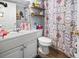 Bathroom with white vanity, toilet, and patterned shower curtain at 3055 Chestnut St., Loris, SC 29569