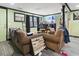 Cozy living room featuring brown sofas and a large TV at 3055 Chestnut St., Loris, SC 29569