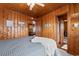 Cozy bedroom with wood paneling and a view into the kitchen at 310 46Th Ave. N, North Myrtle Beach, SC 29582