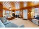 Spacious living room with wood paneling, ample seating and a view to the kitchen at 310 46Th Ave. N, North Myrtle Beach, SC 29582