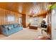 Cozy living room with wood paneled walls and a blue couch at 310 46Th Ave. N, North Myrtle Beach, SC 29582