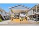 Covered RV parking with a deck and adjacent building at 6001 - 5036 S Kings Highway, Myrtle Beach, SC 29575