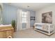 Bedroom featuring a modern crib, light blue patterned walls, and a calming ambiance at 6040 Forest Dell Ct, Myrtle Beach, SC 29579