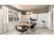 Dining room with a rustic wooden table, six chairs and an abstract art piece at 6056 Forest Dell Ct, Myrtle Beach, SC 29579