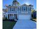 Two-story house with gray siding, a two-car garage, and a well-manicured lawn at 7035 Shooting Star Way, Myrtle Beach, SC 29579