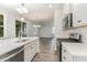 Open concept kitchen with island, stainless steel appliances, and white cabinetry at 7035 Shooting Star Way, Myrtle Beach, SC 29579