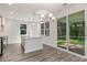 Kitchen with island, white cabinets and access to screened porch at 7047 Shooting Star Way, Myrtle Beach, SC 29579