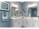 Double vanity bathroom with white cabinets and a corner sink at 7072 Shooting Star Way, Myrtle Beach, SC 29579