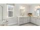 Double vanity bathroom with a large walk-in shower and neutral color palette at 800 Ireland Dr., Longs, SC 29568