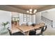 Bright dining room features a farmhouse table and chairs, and an open view to the kitchen at 800 Ireland Dr., Longs, SC 29568