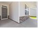 Front porch detail showcasing stonework and a dark brown front door at 1073 Nw Rosefield Way, Calabash, NC 28467