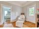 Bedroom with a rocking chair, ottoman and view into another bedroom at 116 Saint James St., Georgetown, SC 29440