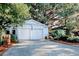 Detached two-car garage with a charming design and gravel driveway at 116 Saint James St., Georgetown, SC 29440