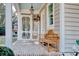 Brick porch with wooden bench and screened-in door at 116 Saint James St., Georgetown, SC 29440