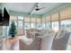 Bright sunroom with a Christmas tree, comfortable seating, and plenty of natural light at 116 Saint James St., Georgetown, SC 29440