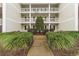 Well-maintained building exterior with landscaping and walkway at 1238 River Oak Dr. # D, Myrtle Beach, SC 29579