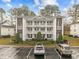 Front view of a three-story condo building with parking at 1238 River Oak Dr. # D, Myrtle Beach, SC 29579