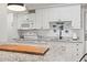 White kitchen with granite counters, wood cutting board, and breakfast bar at 14290 Ocean Hwy. # 407, Pawleys Island, SC 29585