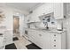 White kitchen with granite countertops and a view of a bathroom at 14290 Ocean Hwy. # 407, Pawleys Island, SC 29585