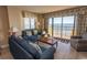 Living room with ocean view, comfortable seating, and balcony access at 2200 N Ocean Blvd., North Myrtle Beach, SC 29582