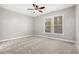 Bright bedroom with ceiling fan and neutral carpeting at 230 Pilot House Pl. # 230, Carolina Shores, NC 28467