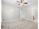 Bedroom with ceiling fan and access to bathroom at 230 Pilot House Pl. # 230, Carolina Shores, NC 28467