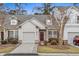 Attractive exterior of a two-story townhome with a garage and well-manicured landscaping at 230 Pilot House Pl. # 230, Carolina Shores, NC 28467