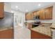 Kitchen boasts granite countertops, stainless steel appliances, and wood cabinets at 230 Pilot House Pl. # 230, Carolina Shores, NC 28467