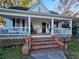 Charming white house with a wraparound porch and brick steps at 306 East Godbold St., Marion, SC 29571