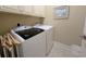 Bright laundry room features washer, dryer, and ample storage at 34 Mingo Dr. # 1D, Pawleys Island, SC 29585