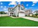 Two-story house with gray siding, stone accents, and a two-car garage at 5433 Merrywind Ct., Myrtle Beach, SC 29579