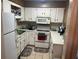 Galley-style kitchen with white cabinets and a built-in microwave at 56 Freedom Way # 56, Myrtle Beach, SC 29577