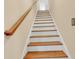 Elegant staircase with wooden handrail and white risers at 5603 Leatherleaf Dr., North Myrtle Beach, SC 29582