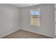 Bright bedroom with carpeted floor and a window overlooking the neighborhood at 60 Cape Point Dr., Conway, SC 29527