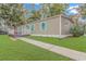 Tan mobile home with teal accents, deck, and landscaped lawn at 6001-Mh81 S Kings Hwy., Myrtle Beach, SC 29575