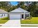 Gray house with white accents, black door, and two-car garage at 656 Castillo Dr., Loris, SC 29569