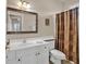 Clean bathroom with white vanity, shower, and decorative curtain at 800 Sunswept Ct. # 102, Murrells Inlet, SC 29576