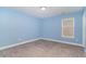 Light blue-painted bedroom with neutral carpeting and window at 8044 Fort Hill Way, Myrtle Beach, SC 29579