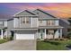 Two-story gray house with a white garage door and green front door, landscaped yard at 8044 Fort Hill Way, Myrtle Beach, SC 29579