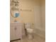 Bathroom with white vanity, toilet, and bathtub; wave patterned tile at 908 Merriman Rd., Georgetown, SC 29440