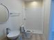 Bathroom with single vanity, toilet, and shower with wave patterned tile at 908 Merriman Rd., Georgetown, SC 29440
