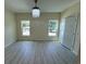 Large bedroom with two windows, chandelier and light grey flooring at 908 Merriman Rd., Georgetown, SC 29440