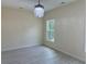 Bright bedroom with window, chandelier, and light grey flooring at 908 Merriman Rd., Georgetown, SC 29440