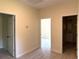 Bright hallway with doors to bedrooms and bathroom, featuring light grey flooring at 908 Merriman Rd., Georgetown, SC 29440