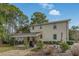 House exterior showcasing a large backyard and covered patio at 917 9Th Ave. S, North Myrtle Beach, SC 29582