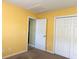 Yellow bedroom with carpet, closet, and open door leading to another room at 1133 Spalding Ct., Surfside Beach, SC 29575