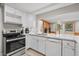 Modern kitchen with white cabinets, stainless steel appliances, and a breakfast bar at 137 Whipporwill Dr, Pawleys Island, SC 29585